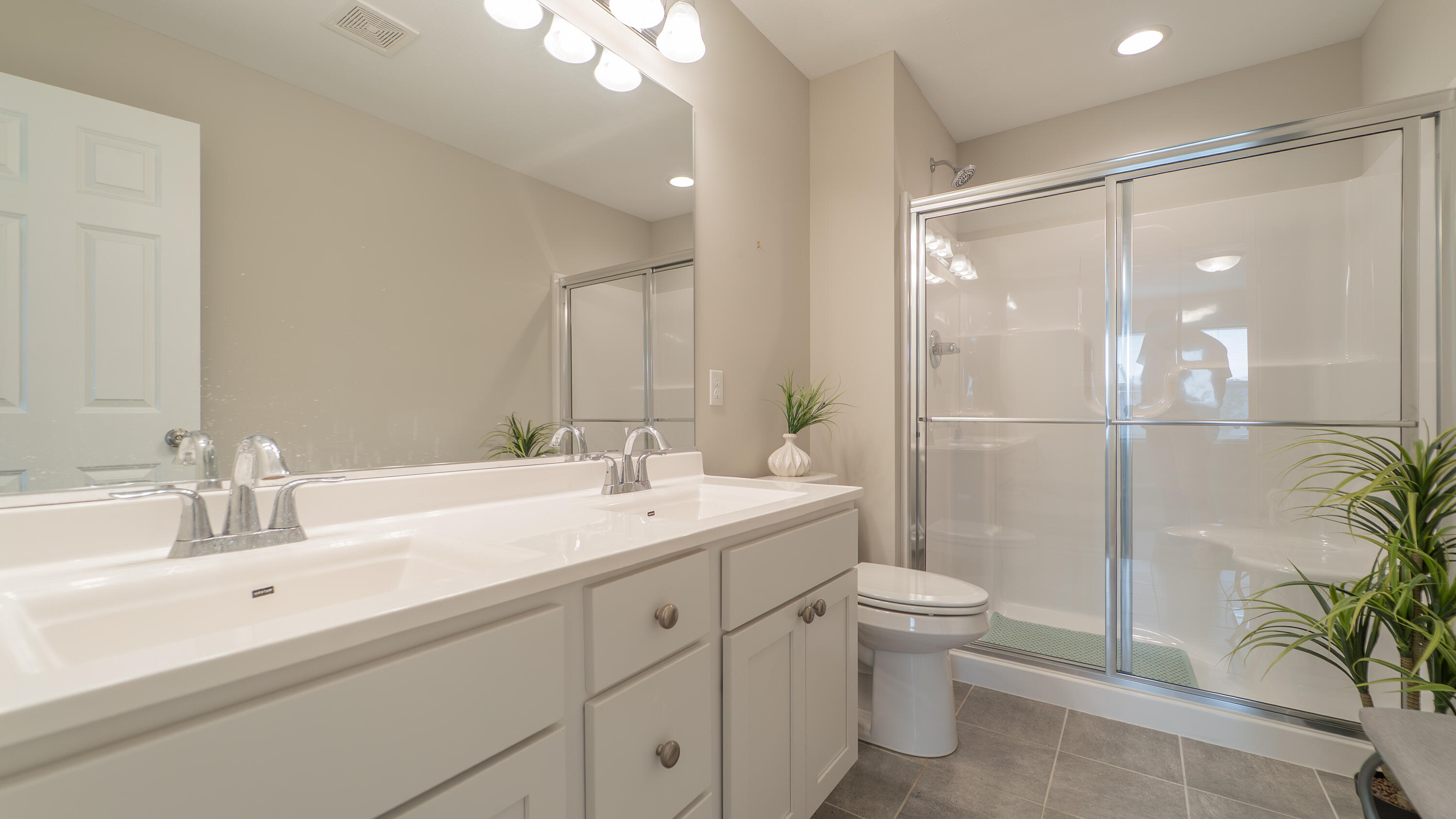 11792 Rhode Island Street Crown Point, IN 46307 - Photo 24 of 30 a bathroom with a double vanity sink toilet and shower