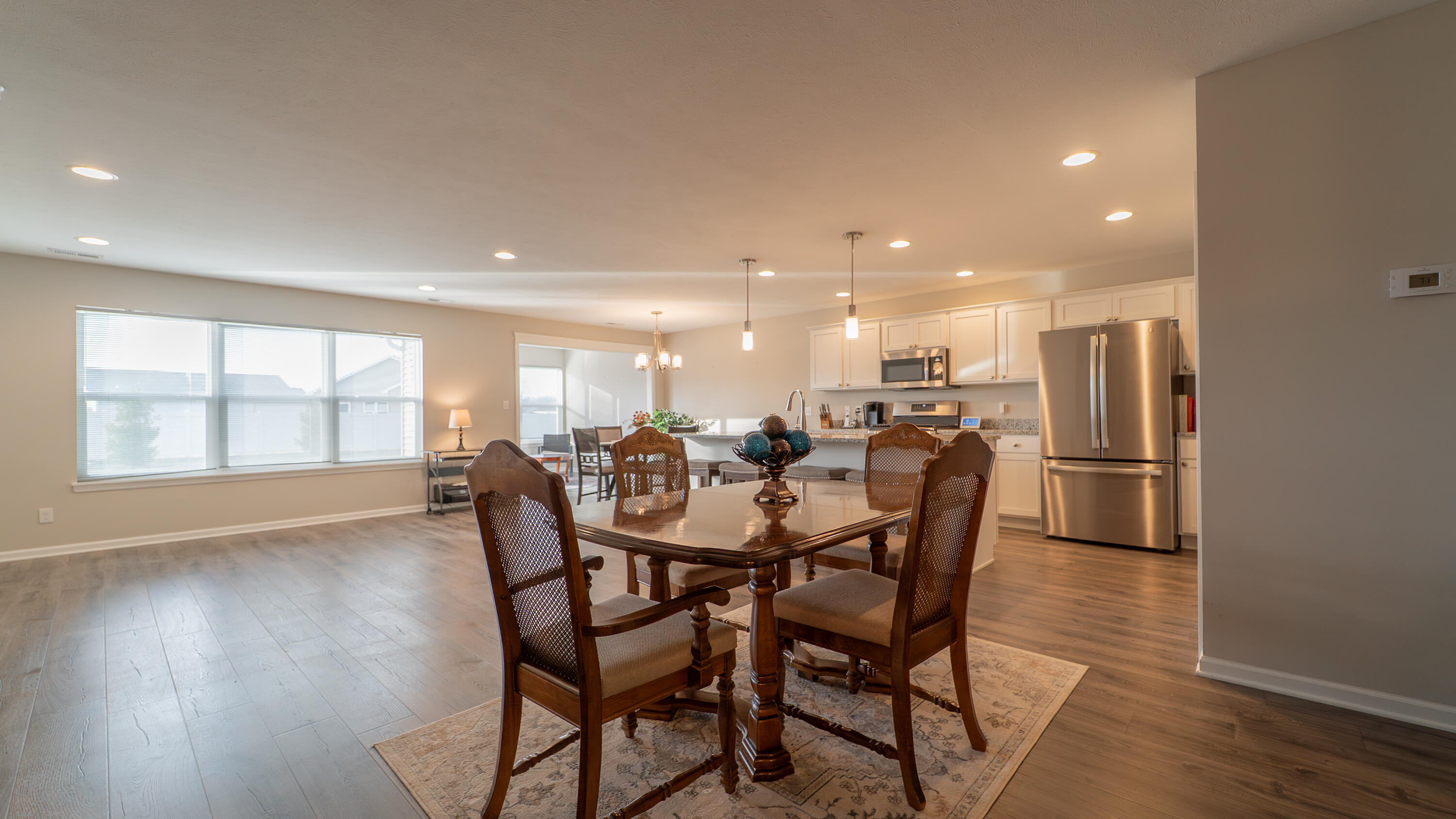 11792 Rhode Island Street Crown Point, IN 46307 - Photo 10 of 30 a dining room with furniture and a kitchen view