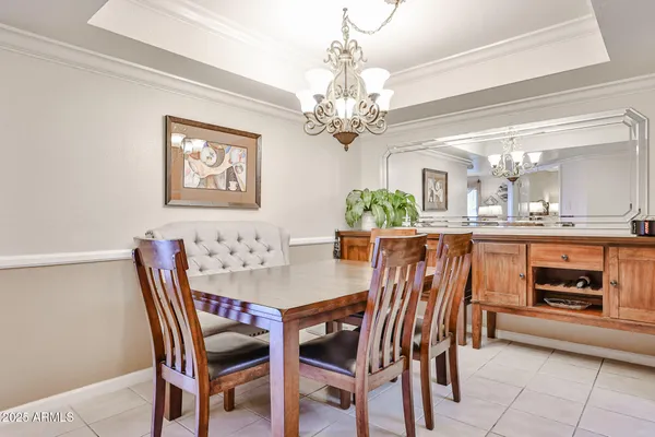a view of a dining room with furniture and a chandelier