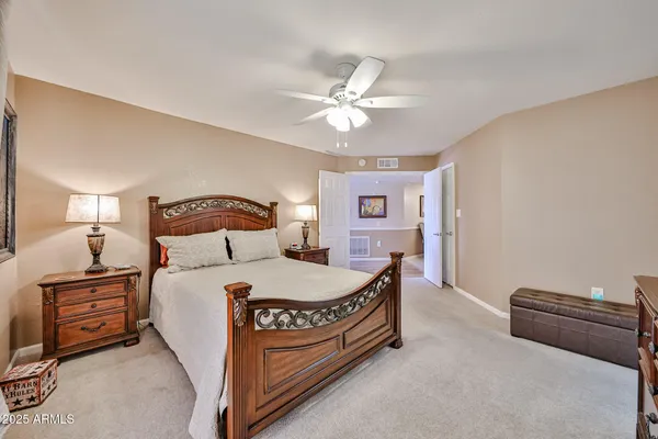 a bedroom with a bed and a chandelier
