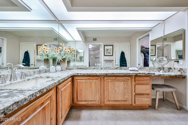 a large kitchen with granite countertop a sink and cabinets