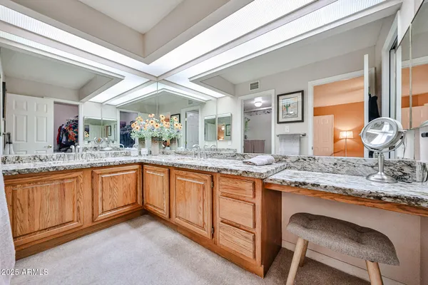 a large bathroom with a sink and a large mirror