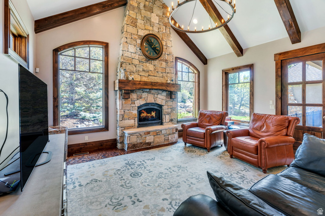 811 South High Ridge Drive Alpine, UT 84004 - Photo 12 of 98 Living area with a stone fireplace, a chandelier, vaulted ceiling, wood finished floors, and plenty of natural light