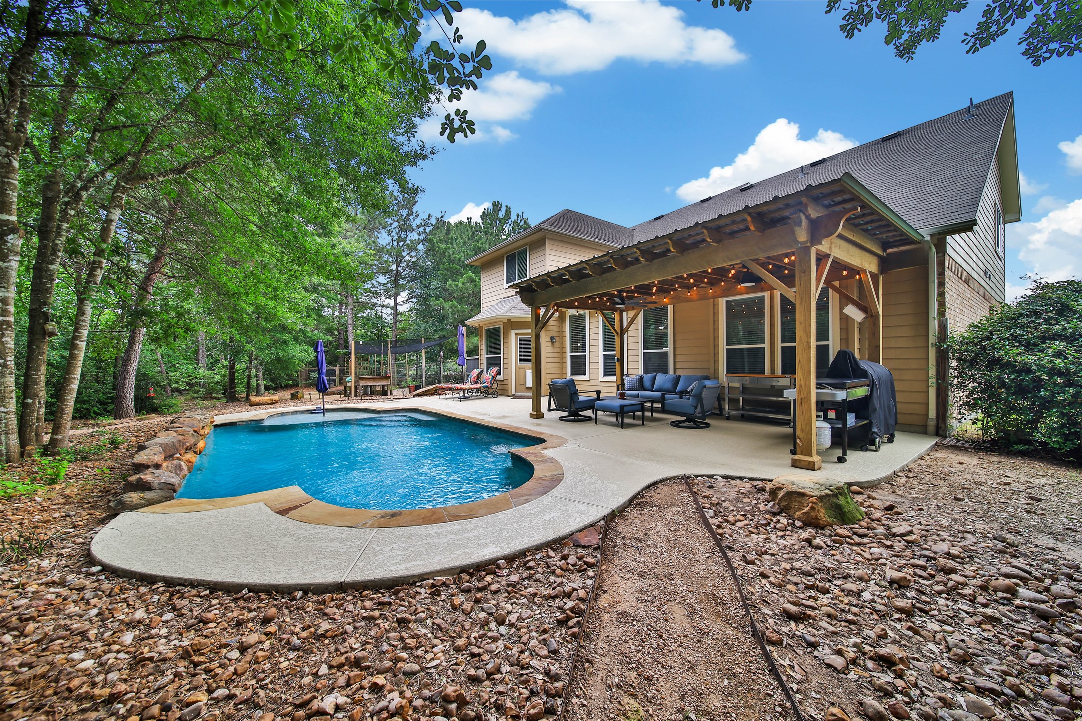 9223 Wapiti Trail Conroe, TX 77303 - Photo 39 of 45 a view of a house with backyard water fountain and sitting area