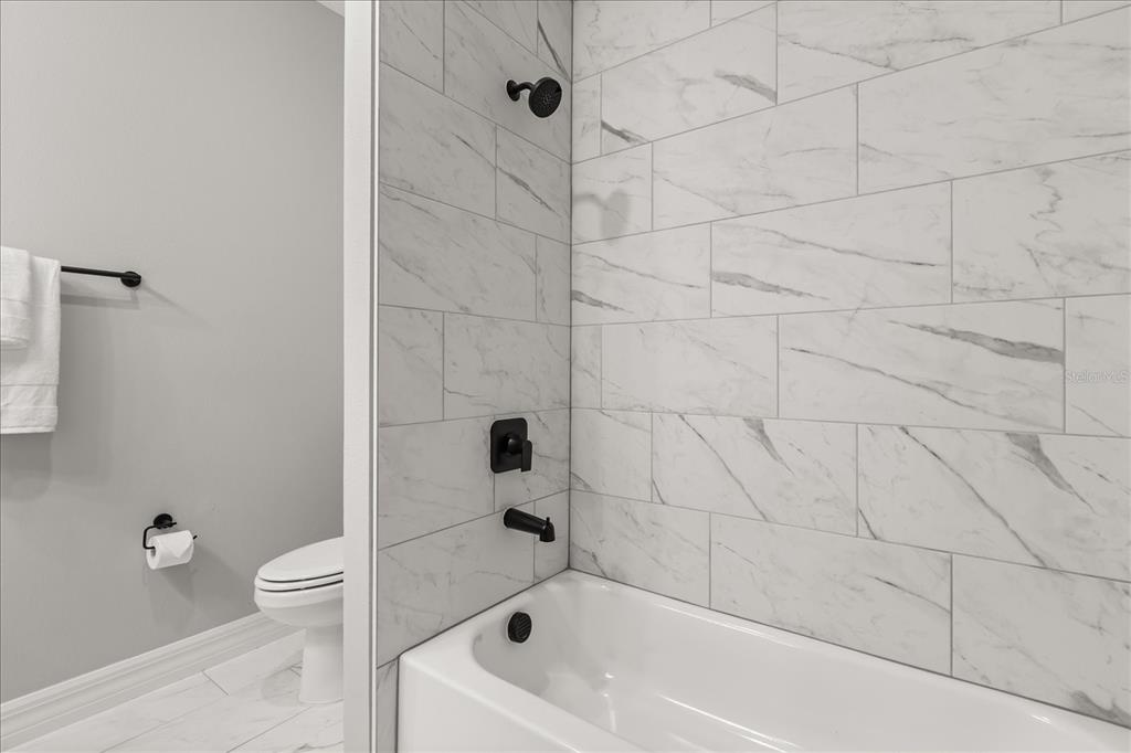 14367 English Sparrow Road Brooksville, FL 34614 - Photo 16 of 30 a bathroom with a bathtub and a toilet