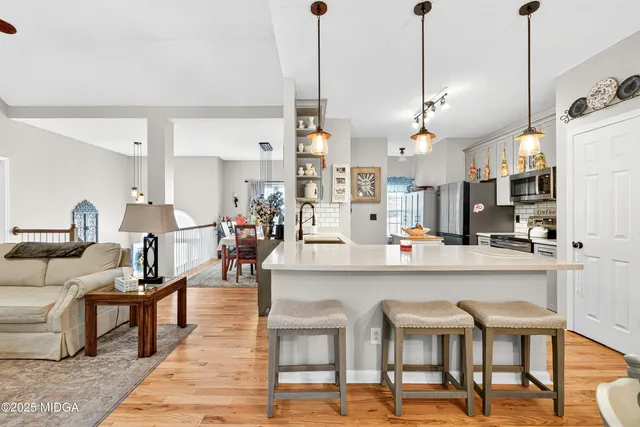a view of a kitchen with dining table and chairs