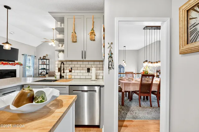 a kitchen with a refrigerator and a chair