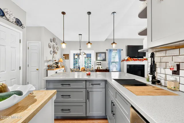 a kitchen with stainless steel appliances kitchen island granite countertop a sink a counter space and cabinets