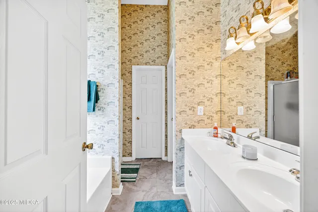 a bathroom with a sink a mirror and a shower