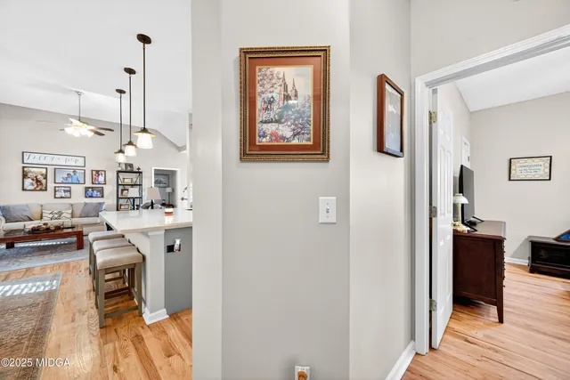 a view of a room with workspace and wooden floor