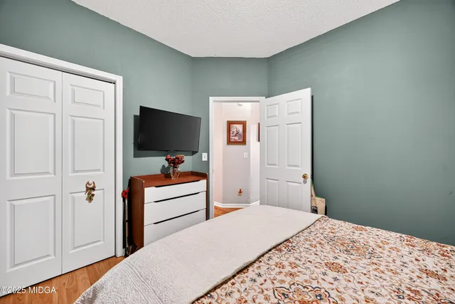 a bedroom with a bed and flat screen tv
