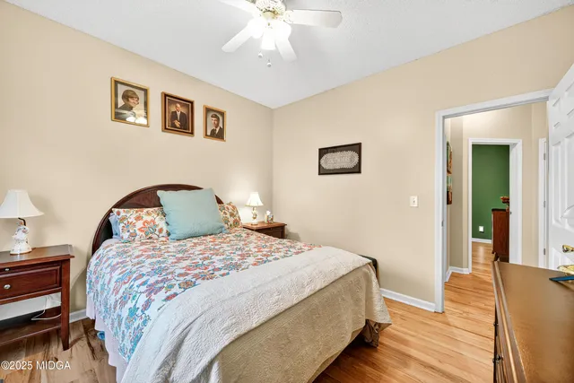 a bedroom with bed and a chandelier