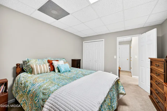 a bedroom with a bed and a mirror