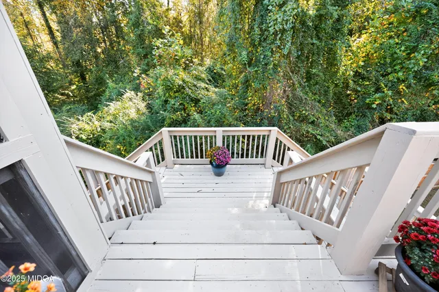 a view of balcony with furniture and garden