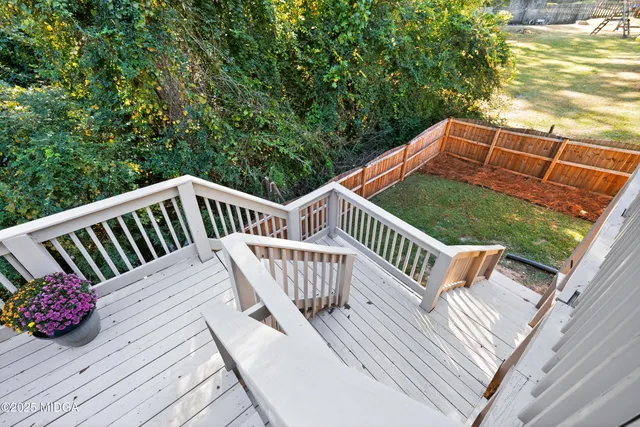 a view of outdoor space with deck and barbeque
