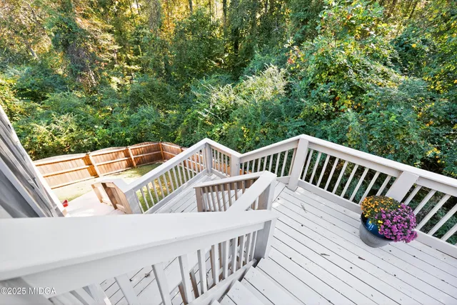 a view of deck with chairs and wooden floor