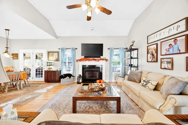 a living room with furniture a fireplace and a flat screen tv
