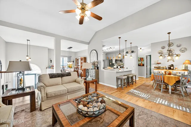 a living room with furniture and a chandelier