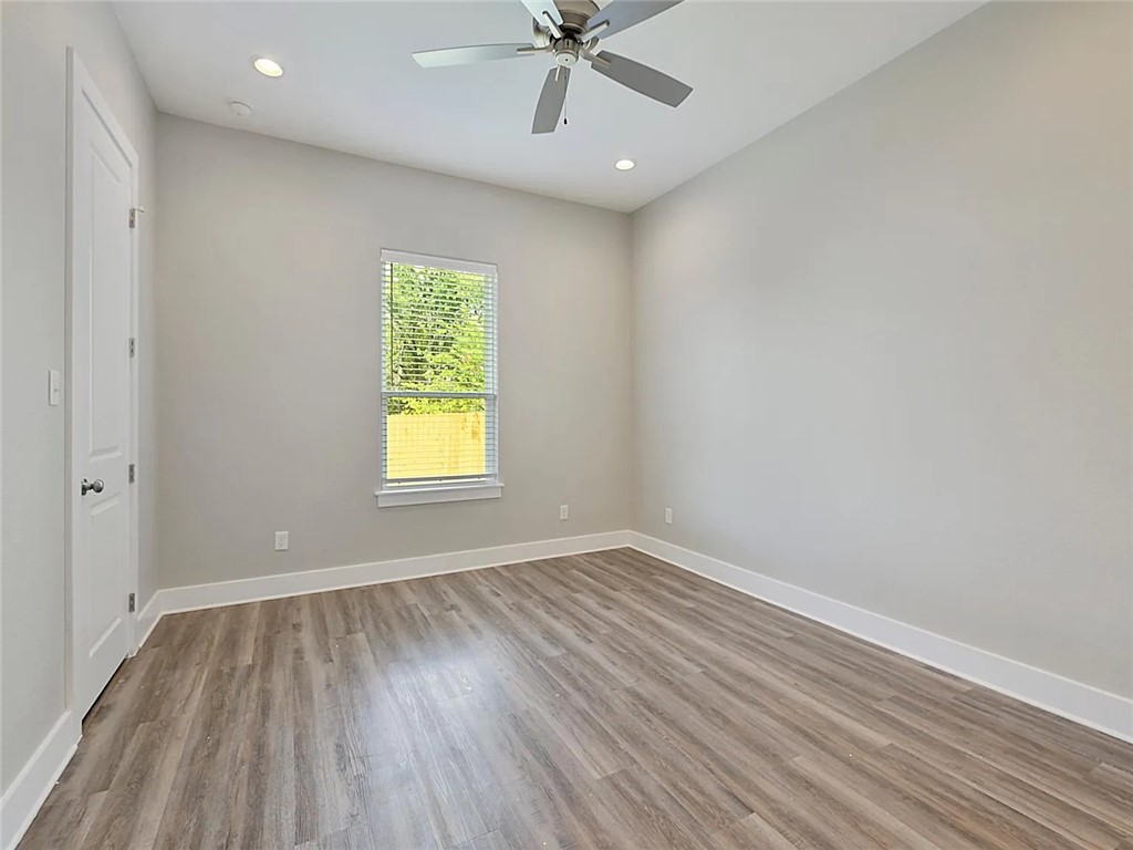 407 Ash Street College Station, TX 77840 - Photo 12 of 14 Unfurnished room with recessed lighting, light wood-style floors, and a ceiling fan