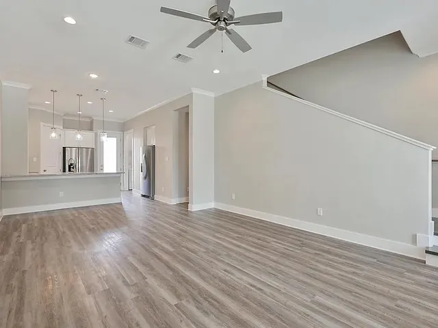 a view of an empty room and wooden floor