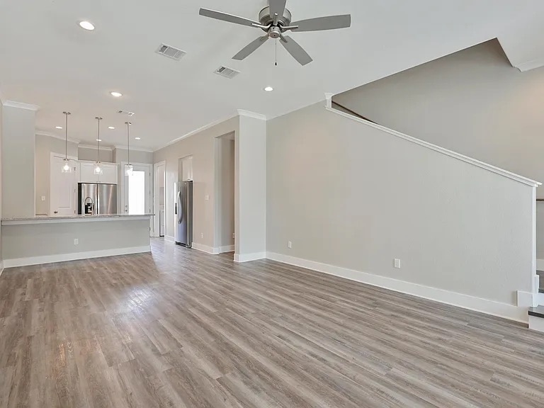 407 Ash Street College Station, TX 77840 - Photo 13 of 14 Unfurnished living room with light wood-style flooring, crown molding, recessed lighting, and a ceiling fan