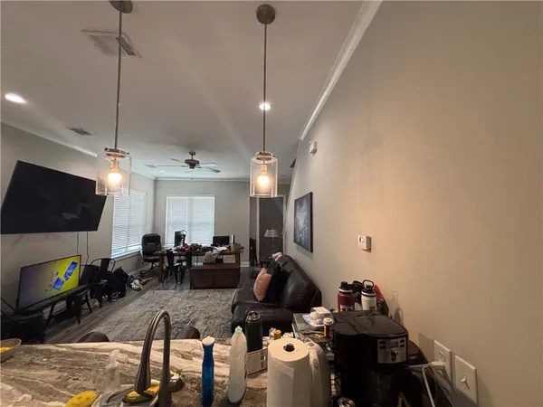 a living room with furniture a flat screen tv and a fireplace