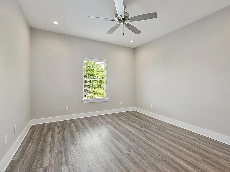 407 Ash Street College Station, TX 77840 - Photo 8 of 14 Spare room with wood finished floors, recessed lighting, and a ceiling fan