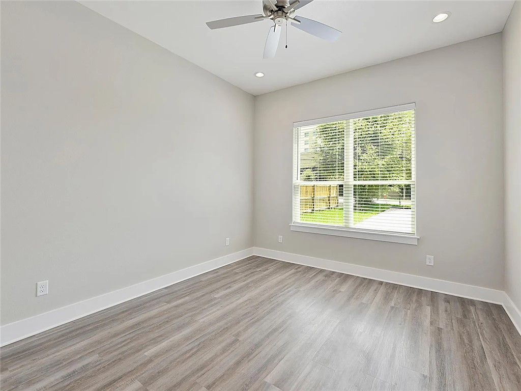 407 Ash Street College Station, TX 77840 - Photo 9 of 14 Empty room featuring recessed lighting, light wood finished floors, and a ceiling fan