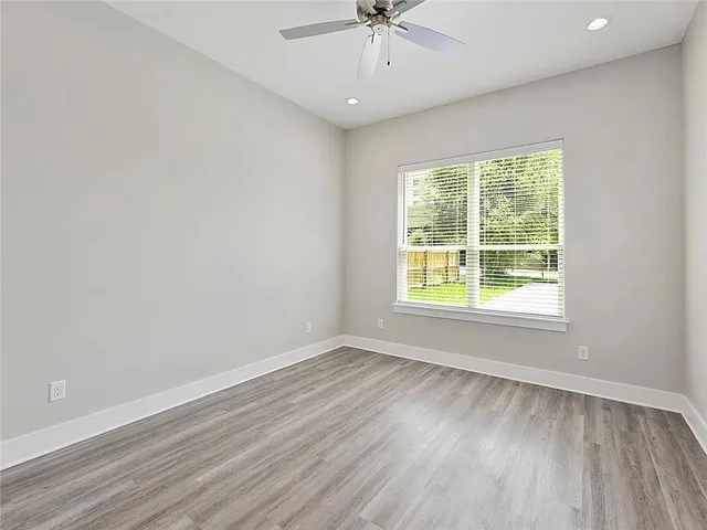 wooden floor in an empty room with a window