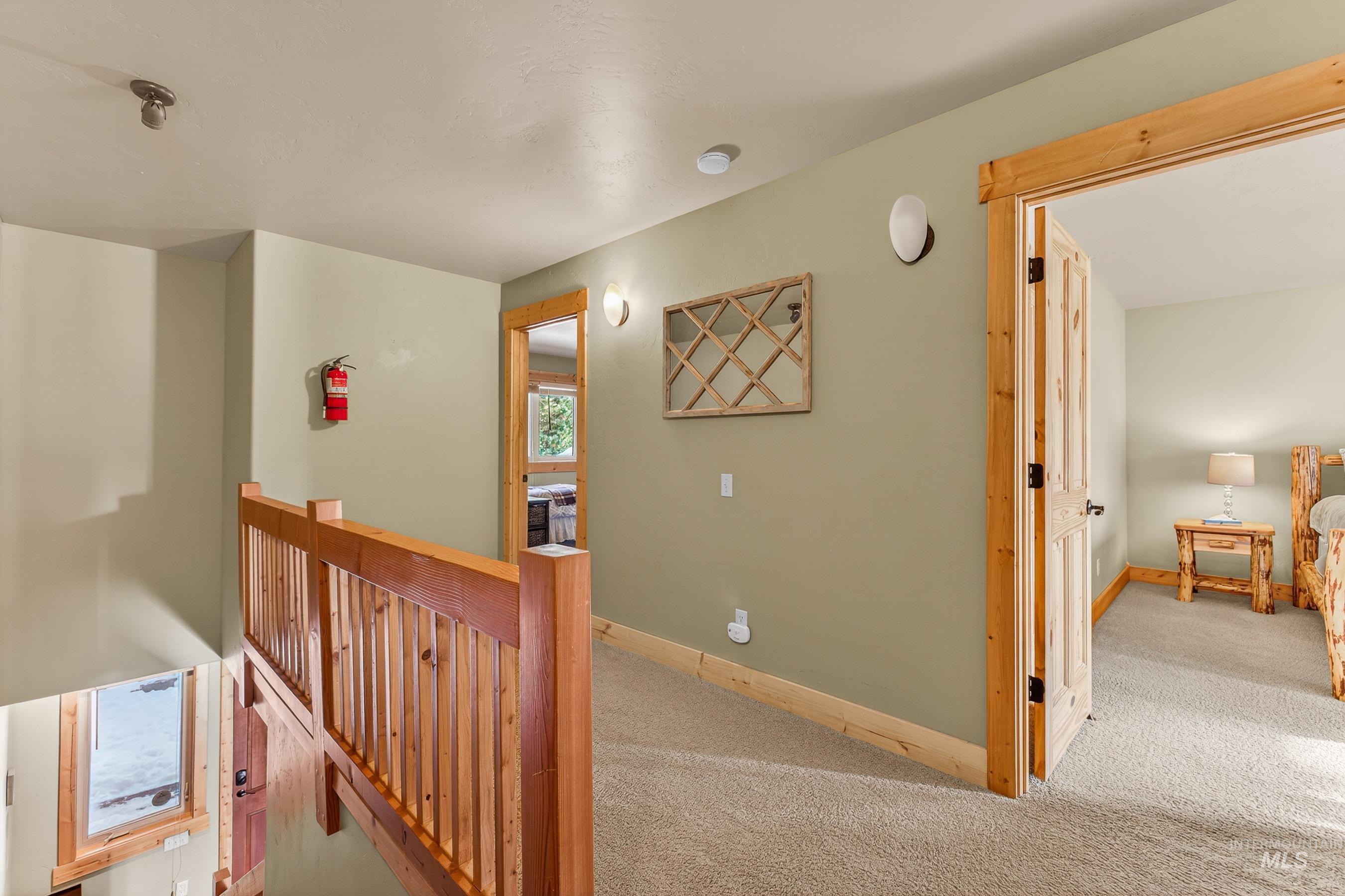 722 Lick Creek Road, Unit 8 McCall, ID 83638 - Photo 23 of 50 Hall with carpet and an upstairs landing