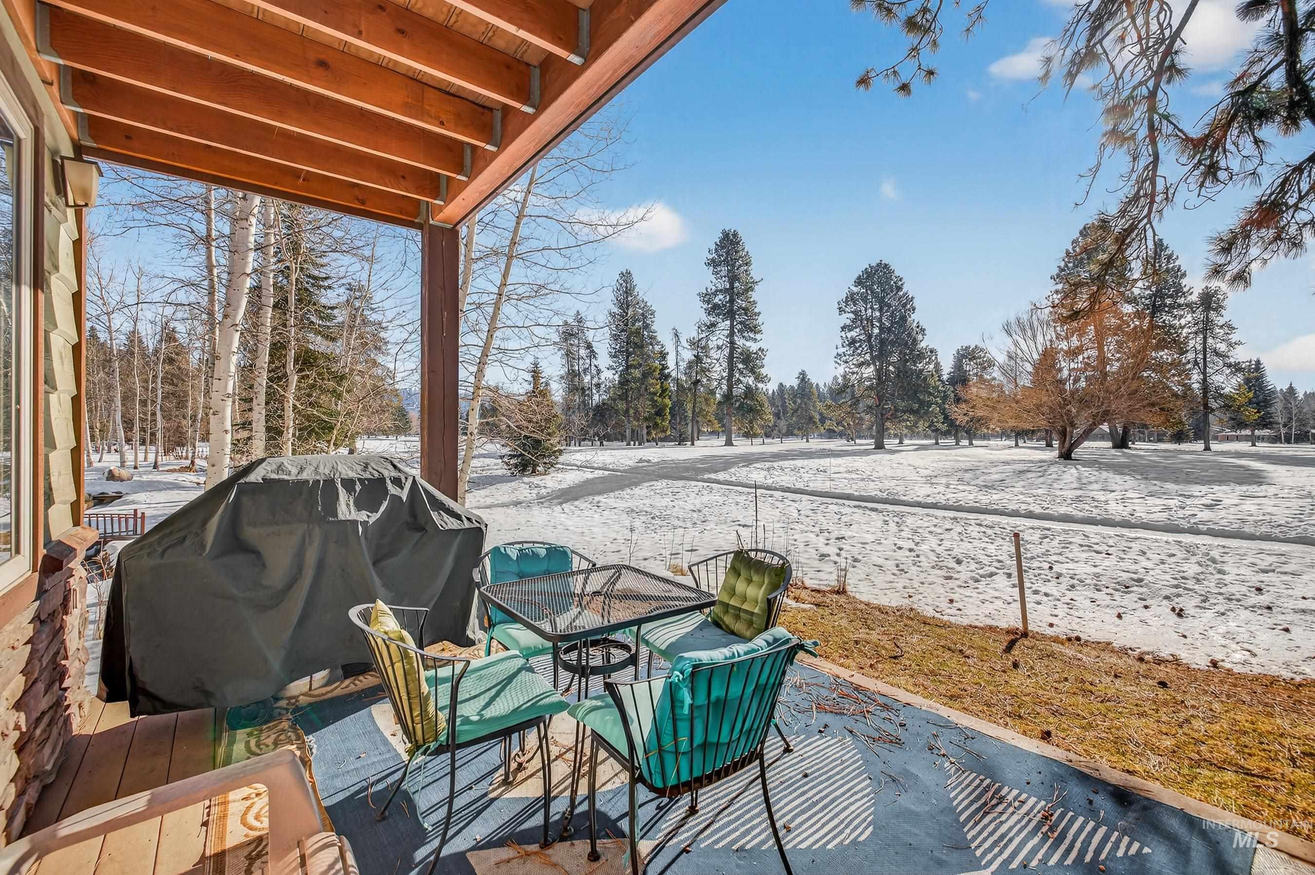 722 Lick Creek Road, Unit 8 McCall, ID 83638 - Photo 38 of 50 Snow covered deck featuring a grill and a patio area