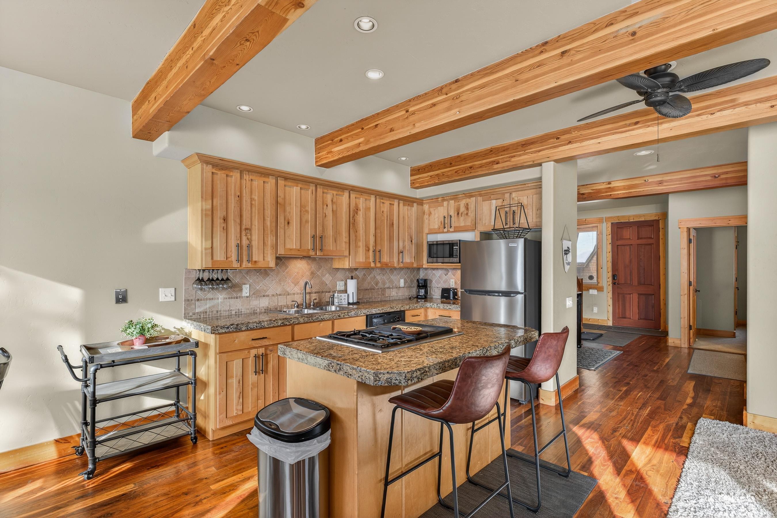 722 Lick Creek Road, Unit 8 McCall, ID 83638 - Photo 7 of 50 Kitchen featuring recessed lighting, a kitchen breakfast bar, a kitchen island, decorative backsplash, and appliances with stainless steel finishes