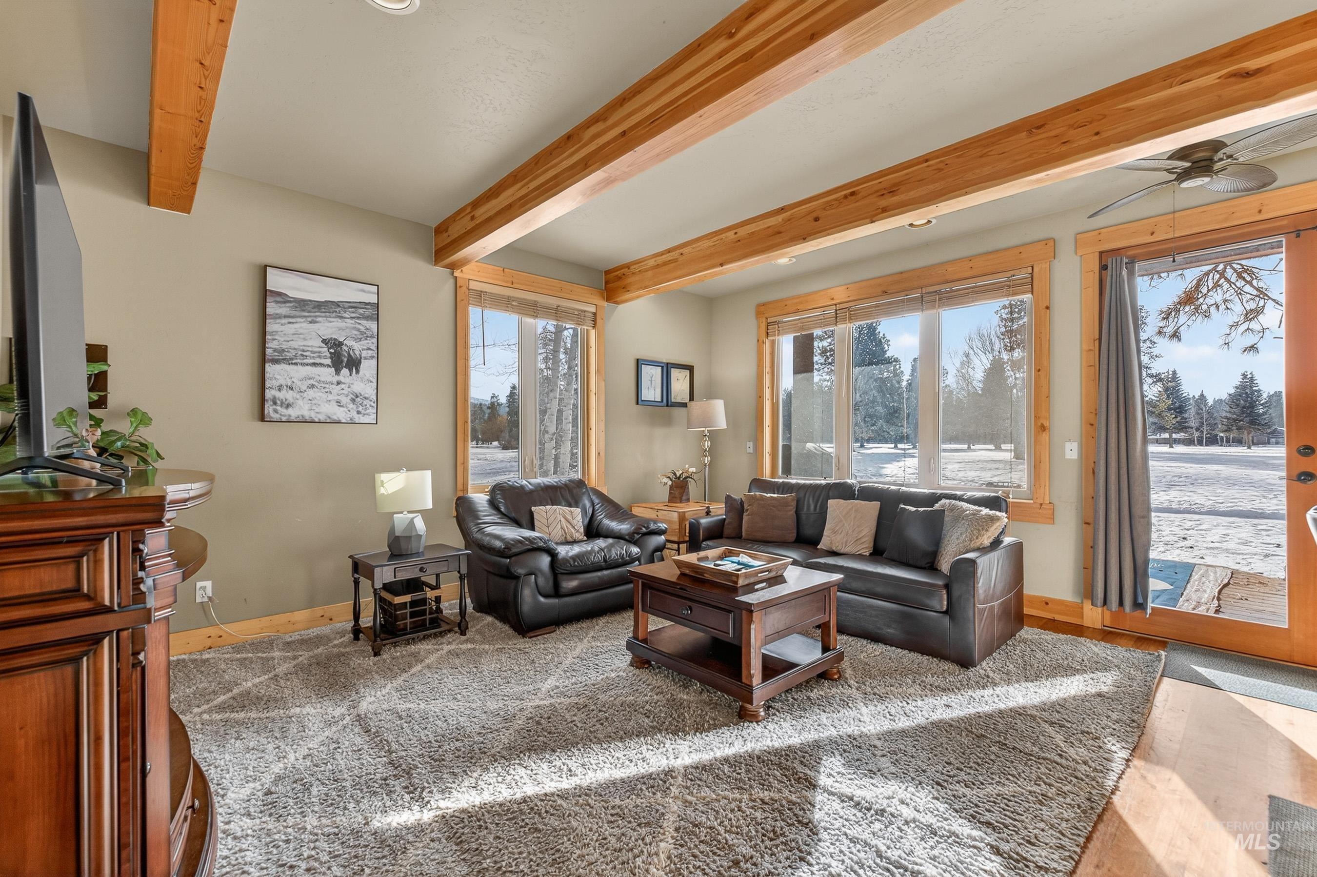 722 Lick Creek Road, Unit 8 McCall, ID 83638 - Photo 8 of 50 Living area featuring ceiling fan and beam ceiling