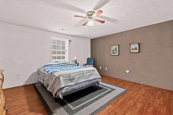 a bedroom with a bed and a ceiling fan