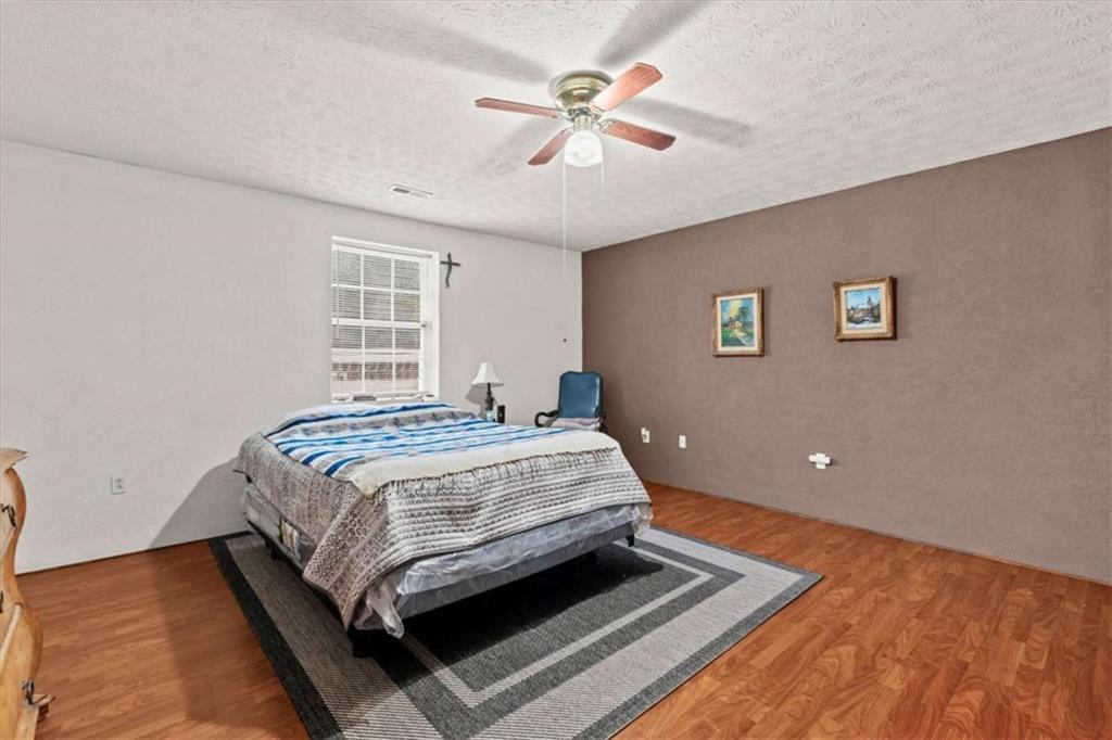 40-l Z L Z Jackson Road Bowdon, GA 30108 - Photo 13 of 25 a bedroom with a bed and a ceiling fan