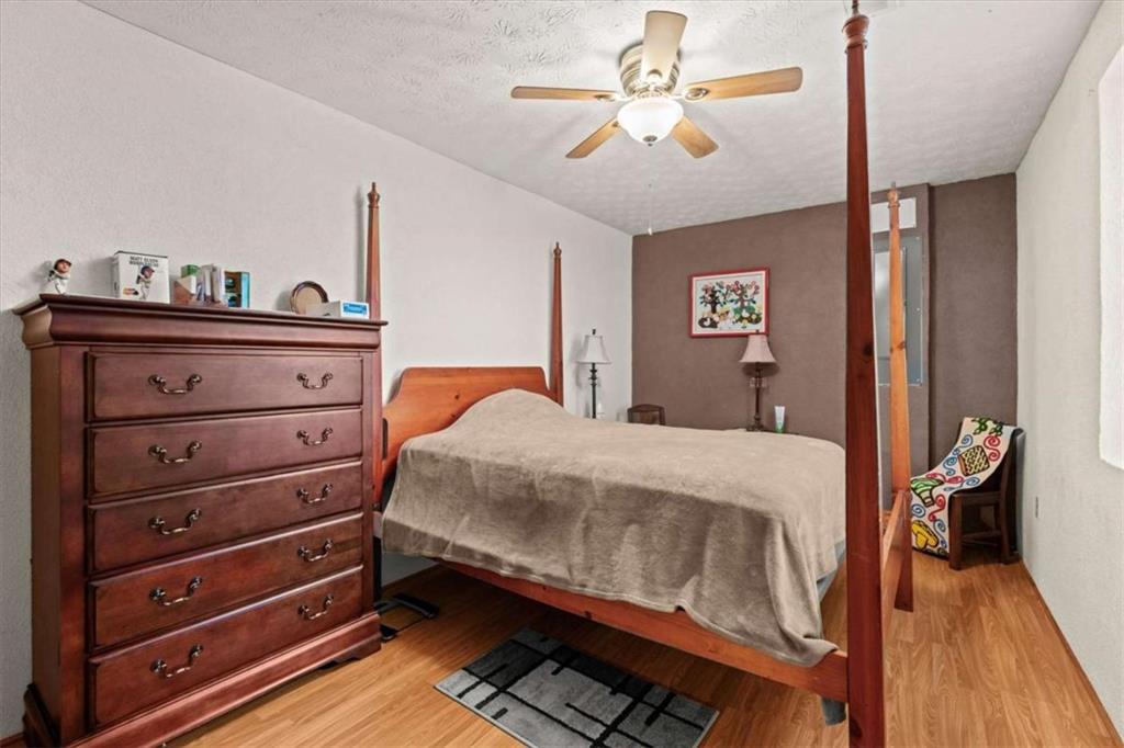 40-l Z L Z Jackson Road Bowdon, GA 30108 - Photo 14 of 25 a bedroom with a bed and a chandelier