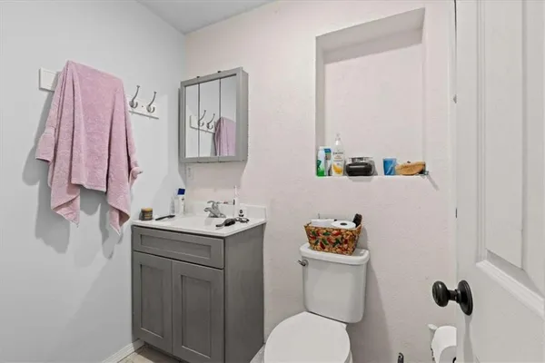 a bathroom with a sink a toilet and a shower curtain