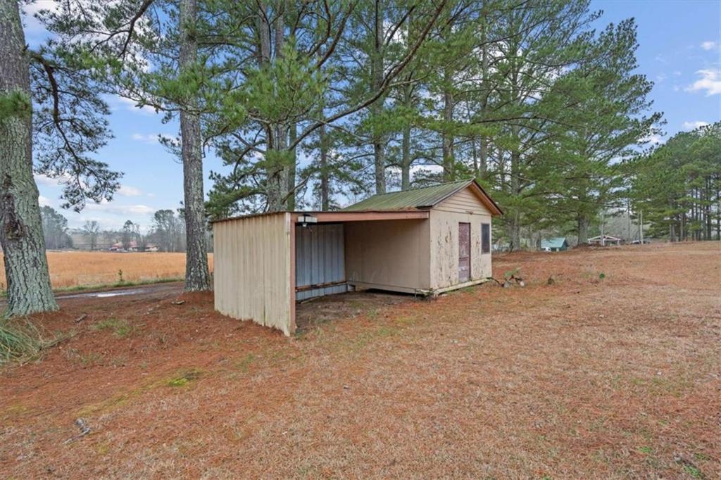 40-l Z L Z Jackson Road Bowdon, GA 30108 - Photo 21 of 25 a wooden house with a tree in front of it