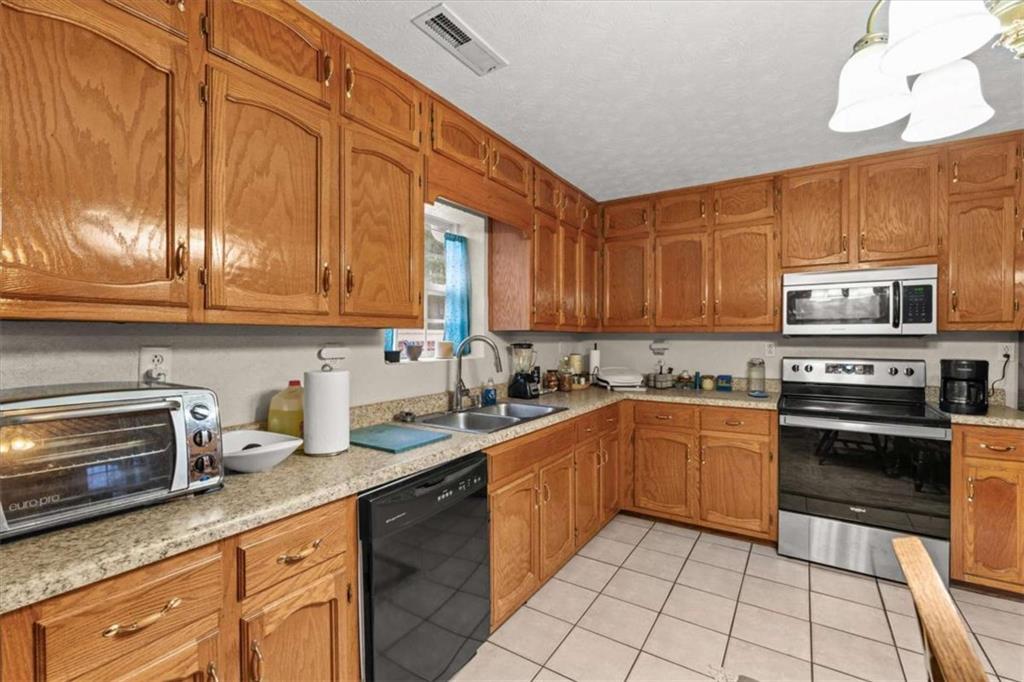 40-l Z L Z Jackson Road Bowdon, GA 30108 - Photo 9 of 25 a kitchen with stainless steel appliances granite countertop a sink a stove and cabinets
