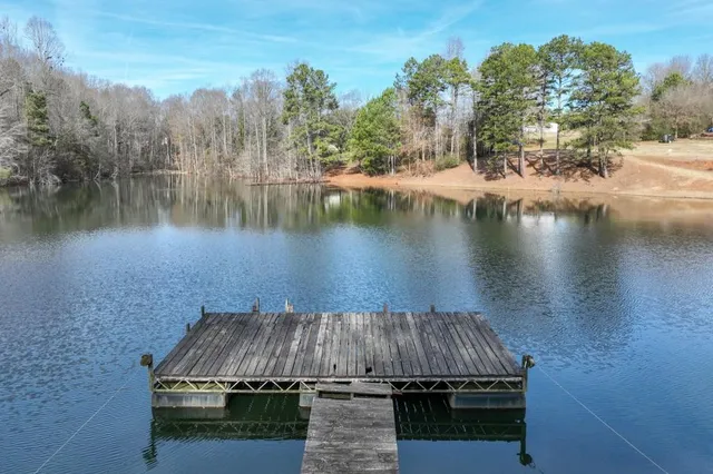 a view of a lake view with a of house in the background