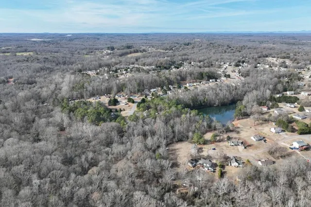 an aerial view of house with yard and mountain in the background