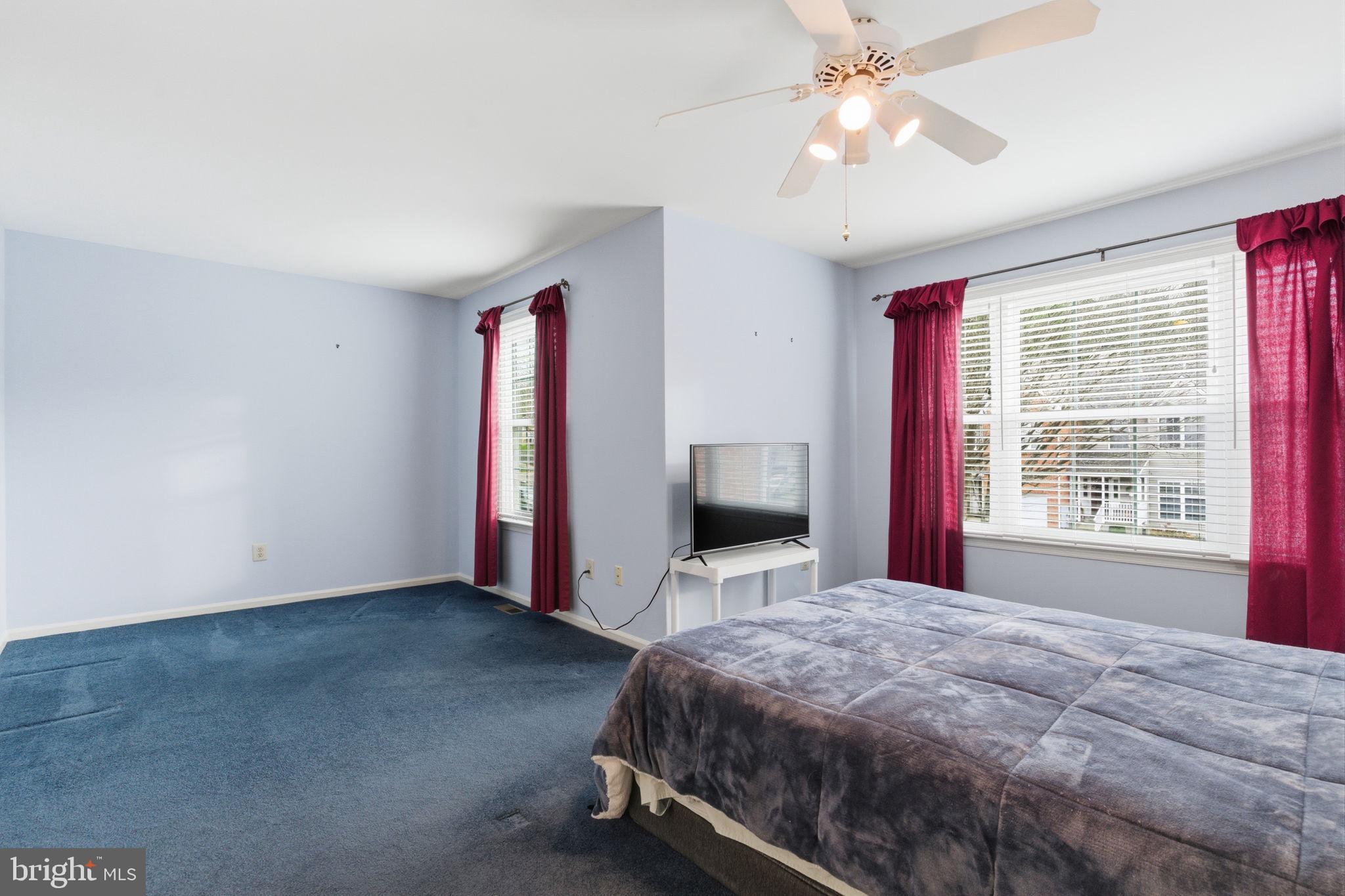 100 Bishops Gate Lane Doylestown, PA 18901 - Photo 17 of 33 a bedroom with a bed and a chandelier