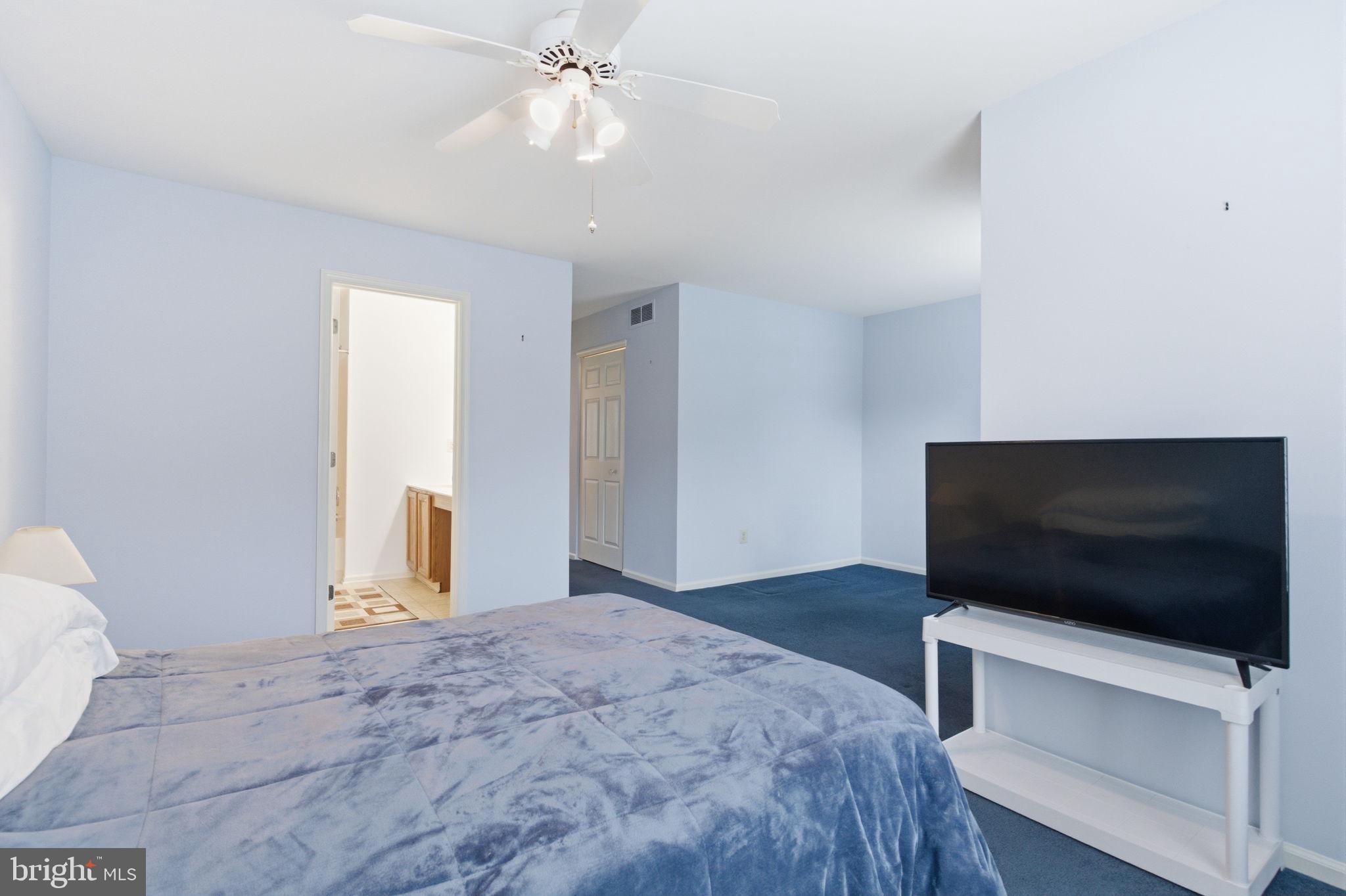 100 Bishops Gate Lane Doylestown, PA 18901 - Photo 18 of 33 a bedroom with a flat screen tv and a ceiling fan
