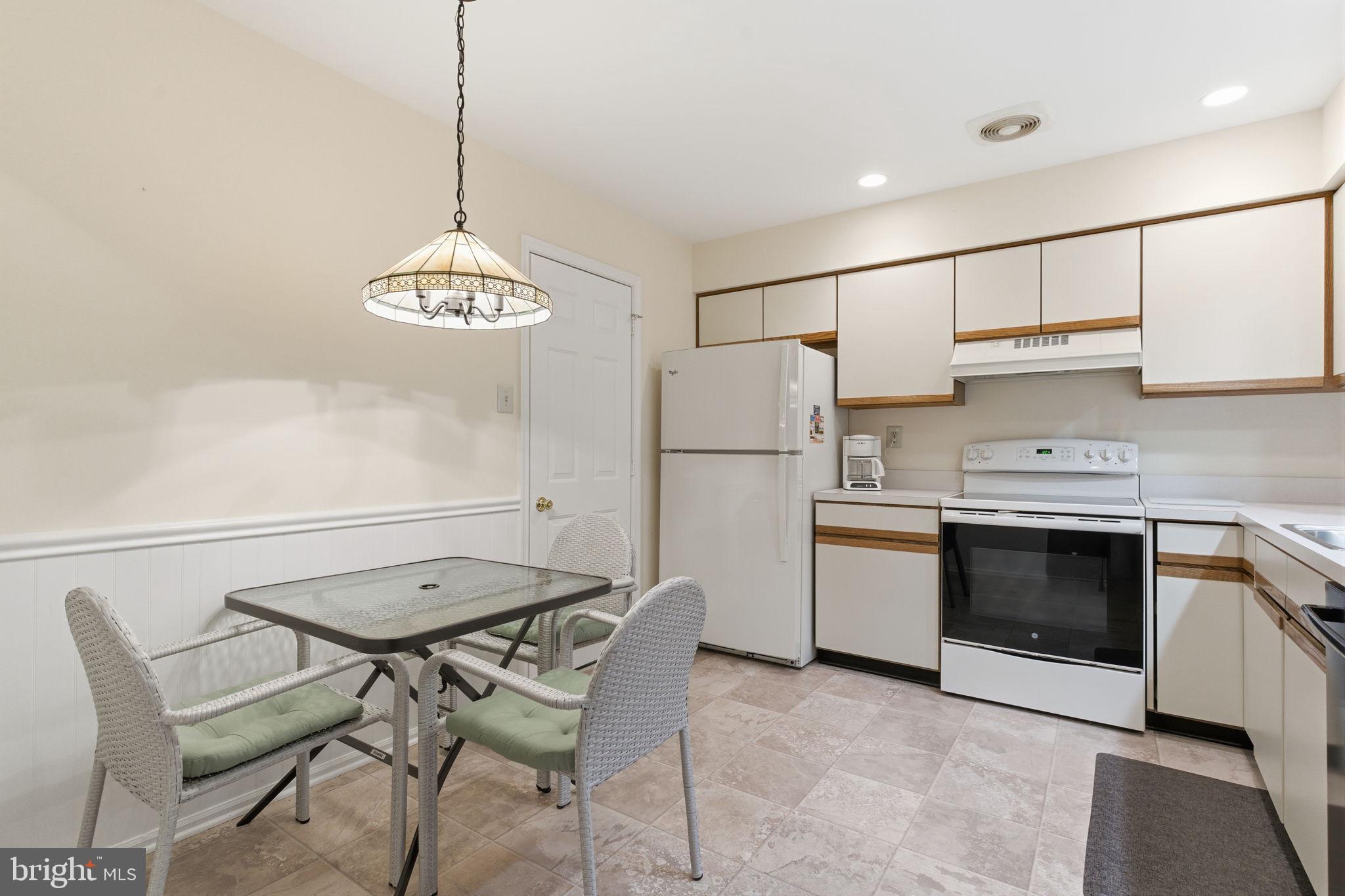 100 Bishops Gate Lane Doylestown, PA 18901 - Photo 5 of 33 a kitchen with stainless steel appliances a stove a refrigerator and a chandelier