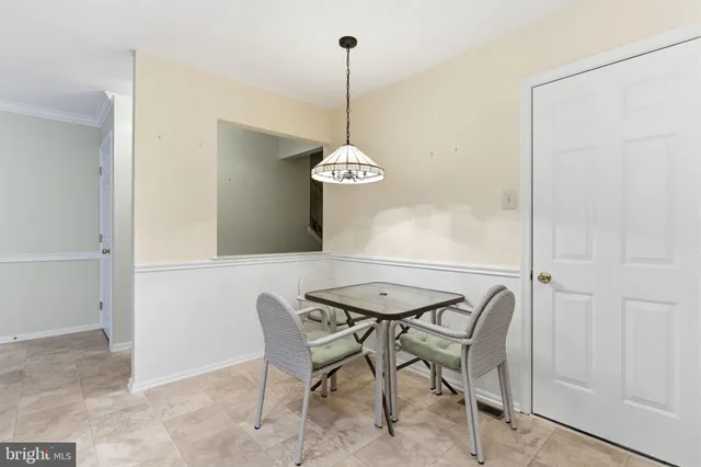 a dining room table chairs and a chandelier