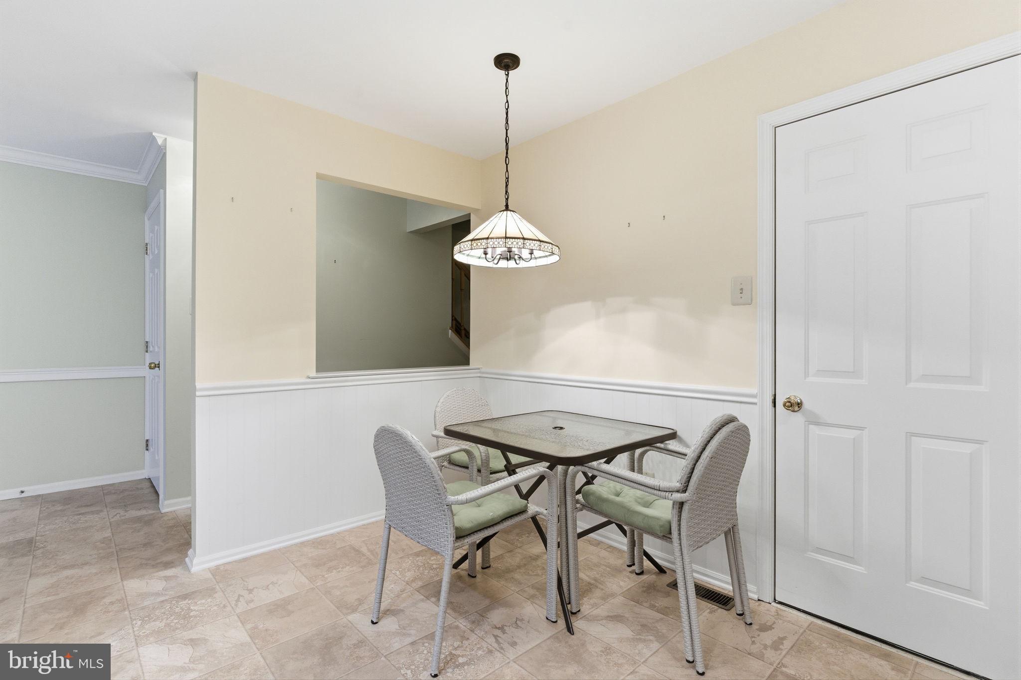 100 Bishops Gate Lane Doylestown, PA 18901 - Photo 6 of 33 a dining room table chairs and a chandelier
