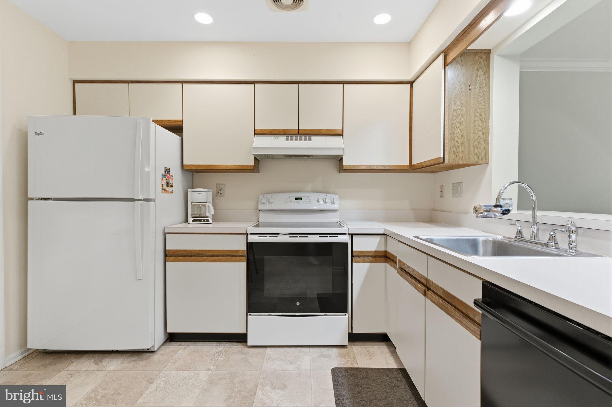 100 Bishops Gate Lane Doylestown, PA 18901 - Photo 7 of 33 a kitchen with a white stove top oven and refrigerator