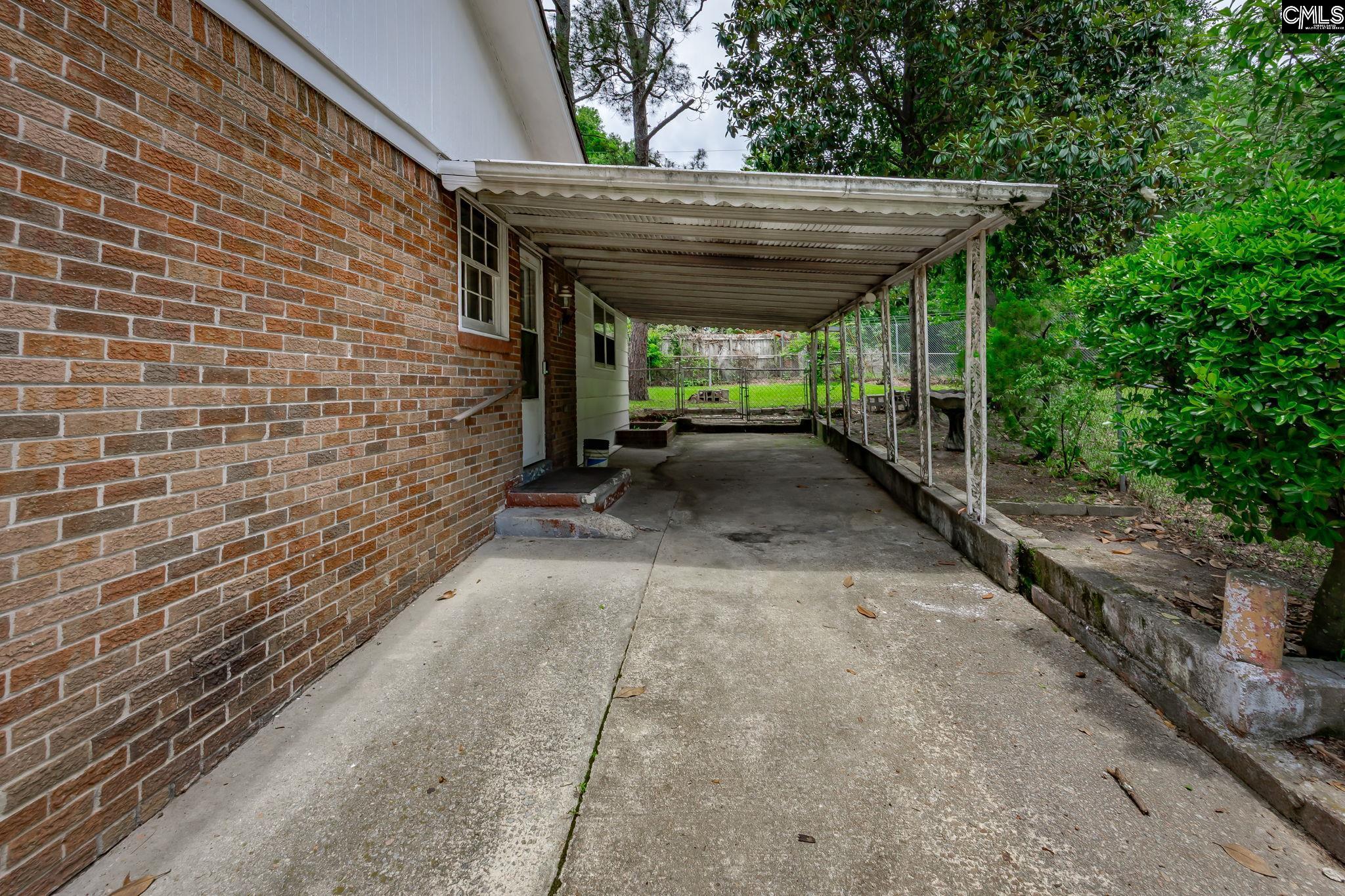 5666 Middleton Court Columbia, SC 29203 - Photo 6 of 42 a view of a patio with table and chairs with wooden fence