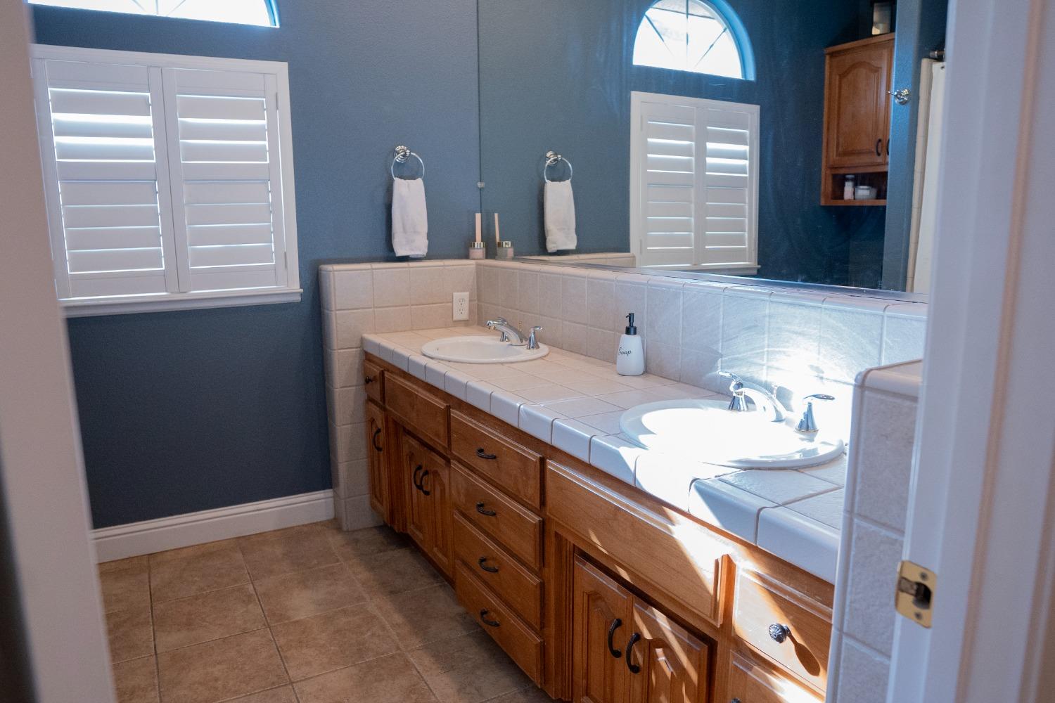2607 Norwich Avenue Clovis, CA 93611 - Photo 27 of 55 a bathroom with a double vanity sink and a mirror