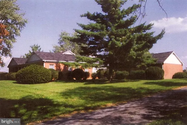 a front view of a house with a garden and pathway
